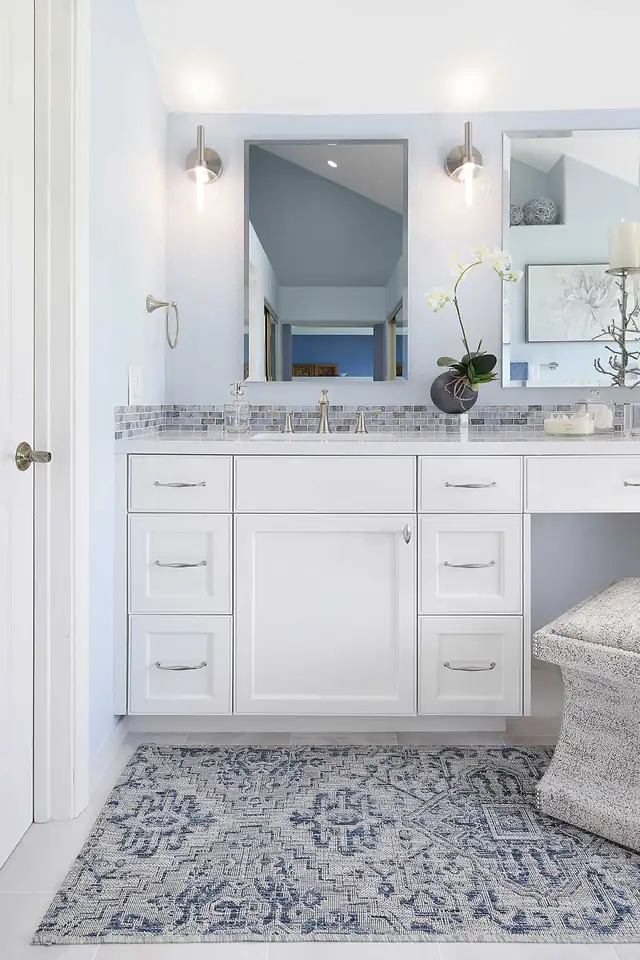 Aging-in-place primary bathroom in Danville, CA with white vanity, seated makeup counter and patterned floor tile
