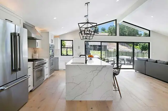 Contemporary kitchen and great room in Alamo, CA with waterfall-edge island and black-framed glass doors