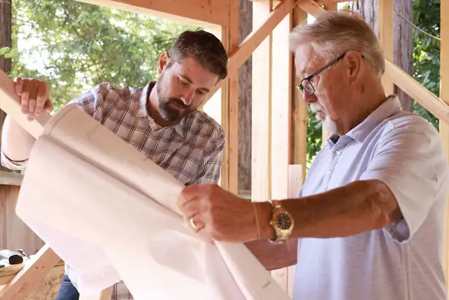 Chris Gayler and his father George Gayler reviewing floor plans