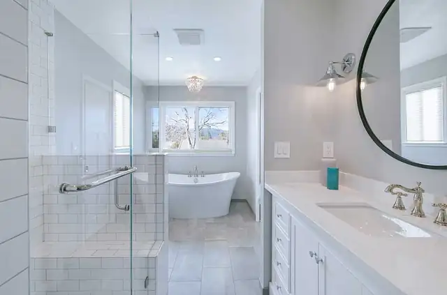 Transitional bathroom remodel in Pleasanton, CA with frameless glass shower, freestanding tub and white vanity